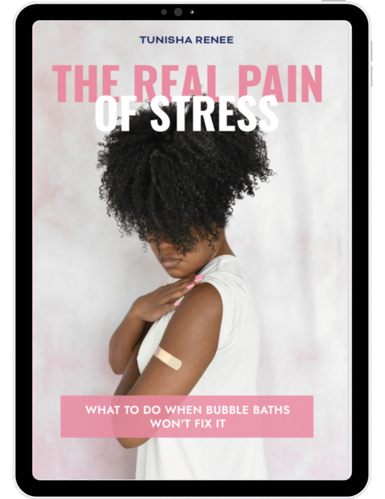 Tablet display showing the book cover for The Real Pain of Stress by Tunisha Renee. The cover features a woman with curly hair wearing a white top, looking down with one hand on her shoulder, where a beige bandage is visible. The title text reads ‘THE REAL PAIN OF STRESS’ in bold pink and white letters, and the subtitle says ‘What to Do When Bubble Baths Won’t Fix It’ in white text on a pink banner.